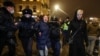 Russian police officers detain a woman during a February 2, 2021 demonstration in Moscow against the sentencing of Russian opposition leader Aleksei Navalny to prison. 