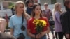 Parents and children in Kazan wait to leave flowers and stuffed animals at a memorial to the victims of the May 11, 2021 attack on School No. 175. 