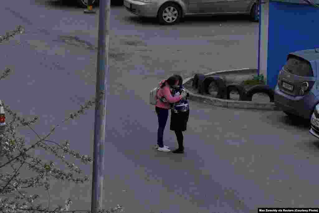 A woman embraces a child after the deadly shooting at Kazan&#39;s School No. 175. Over 1,000 children of elementary-school to high-school ages attend the public school.&nbsp;