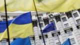 Ukraine -- Ukrainian national flags, flags of Ukrainian trade unions and EU flag are seen during a mass rally in front of the Ukrainian cabinet of ministers building in Kyiv, October 15, 2014