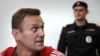 Russian opposition figure Aleksei Navalny (left) attends a court hearing in Moscow on August 22, 2019.