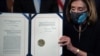 U.S. House of Representatives Speaker Nancy Pelosi (Democrat-California) displays the signed Article of Impeachment against President Donald Trump on January 13, 2021. 